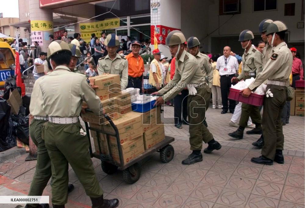 Relief supplies arrive near crumbled hotel