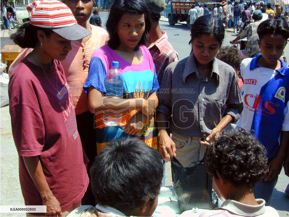 People shop for food in Dili