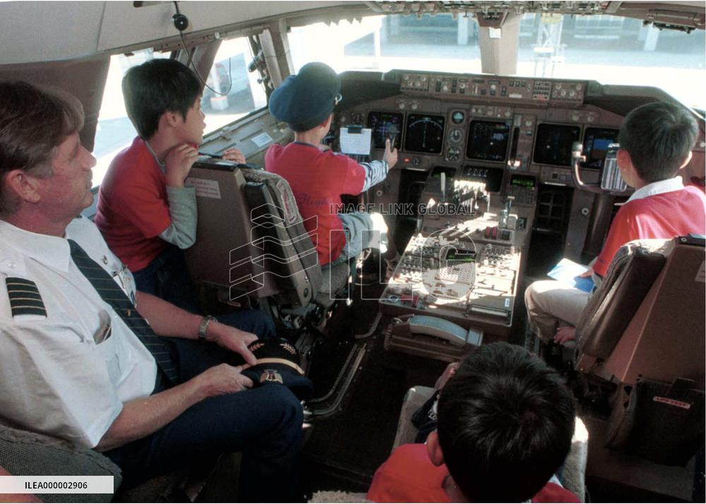 80 kids enjoy tour of jumbo jet at Narita airport