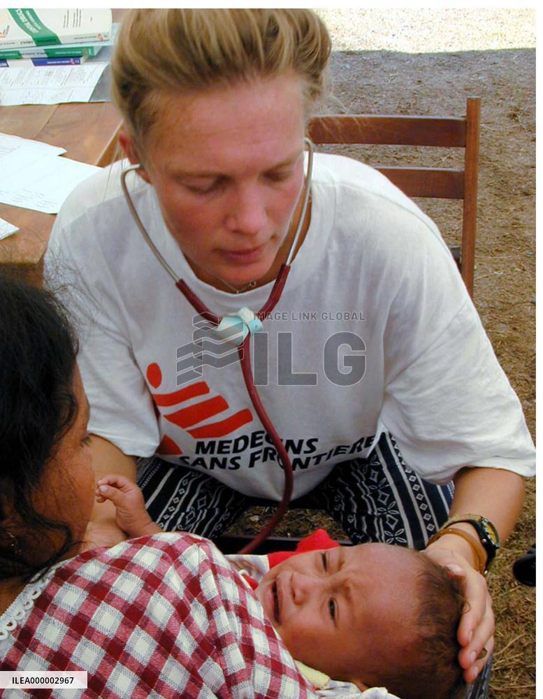 Doctors Without Borders worker examines baby in Dili