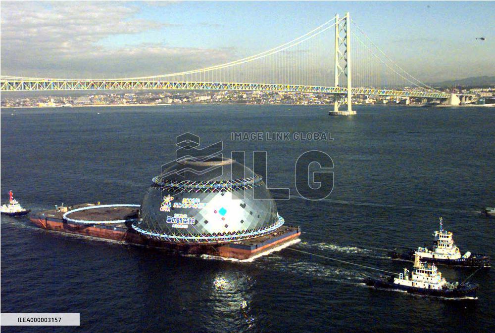 Hemispherical glass dome passes under Akashi Bridge