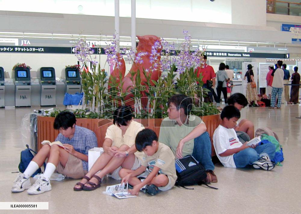 Powerful typhoon force passengers to wait at airport