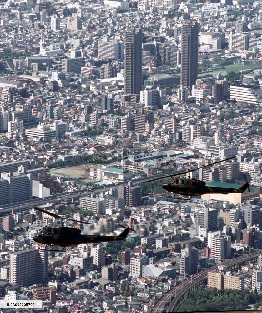 Air defense choppers hover over Tokyo skyscrapers