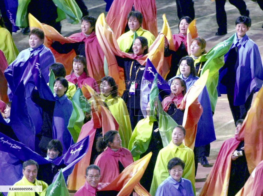 Multi-colored capes-wearing Japanese delegates march into stadiu