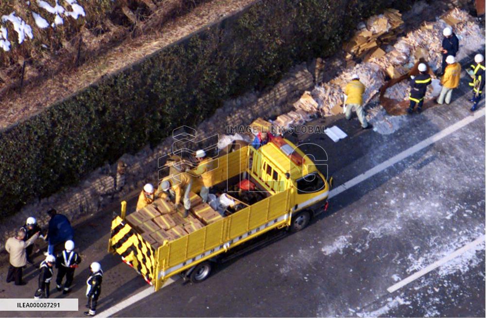 Workers clean up explosives spilled in road accident