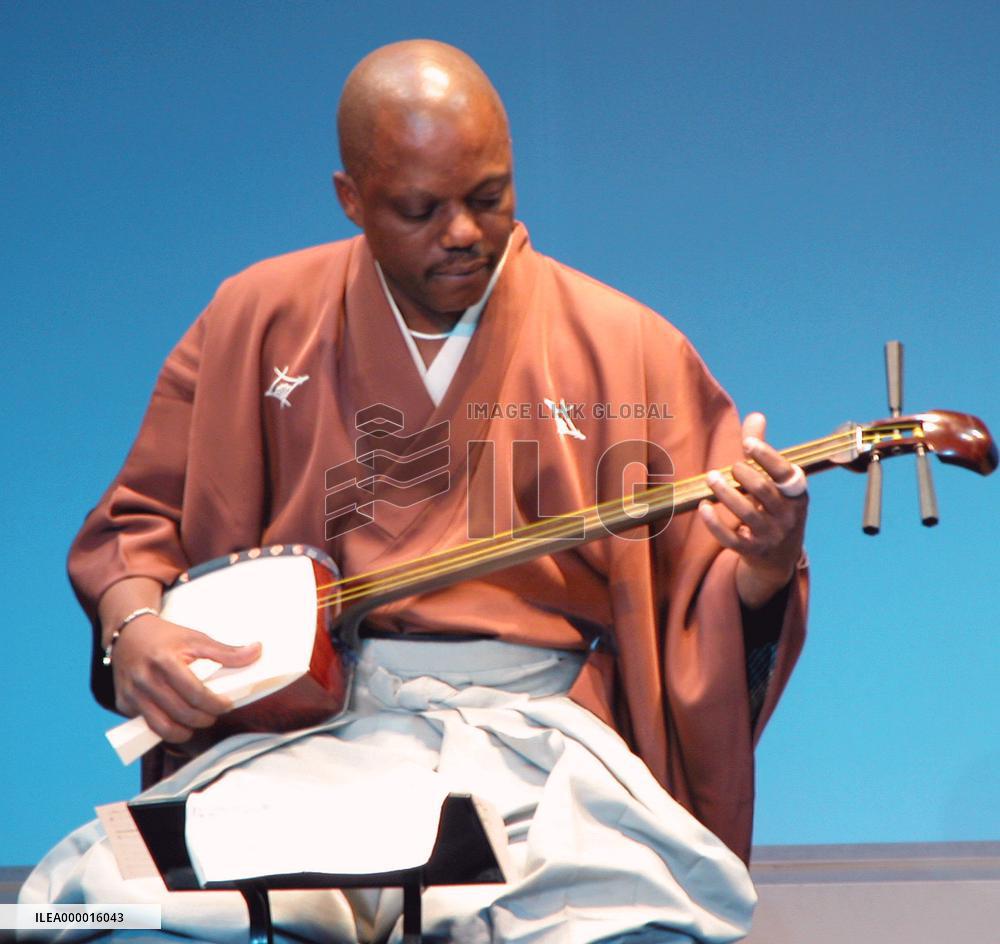 Cameroon's W. Vincent performs samisen as accredited player