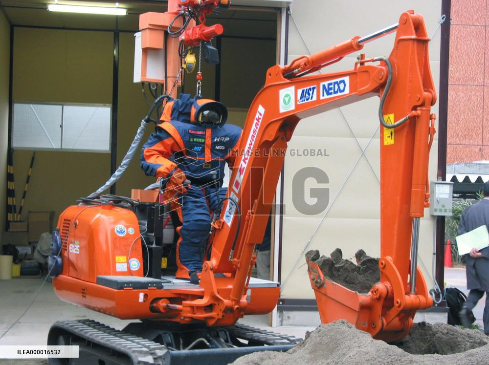 Remote-controlled robot operates power shovel