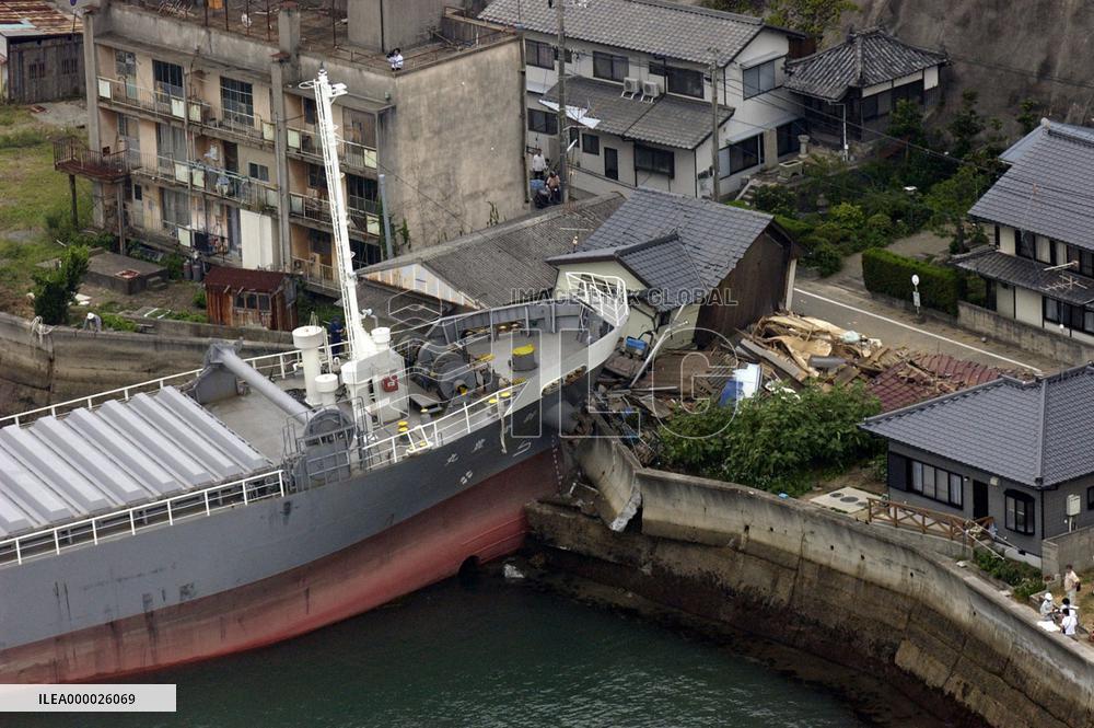 Drowsy skipper runs freighter into houses ashore
