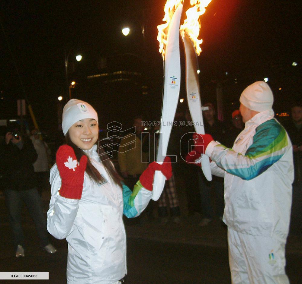 Figure skater Kim carries Olympic torch