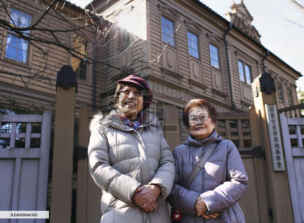 Transsexual poses with partner in front of former Tokyo Music School