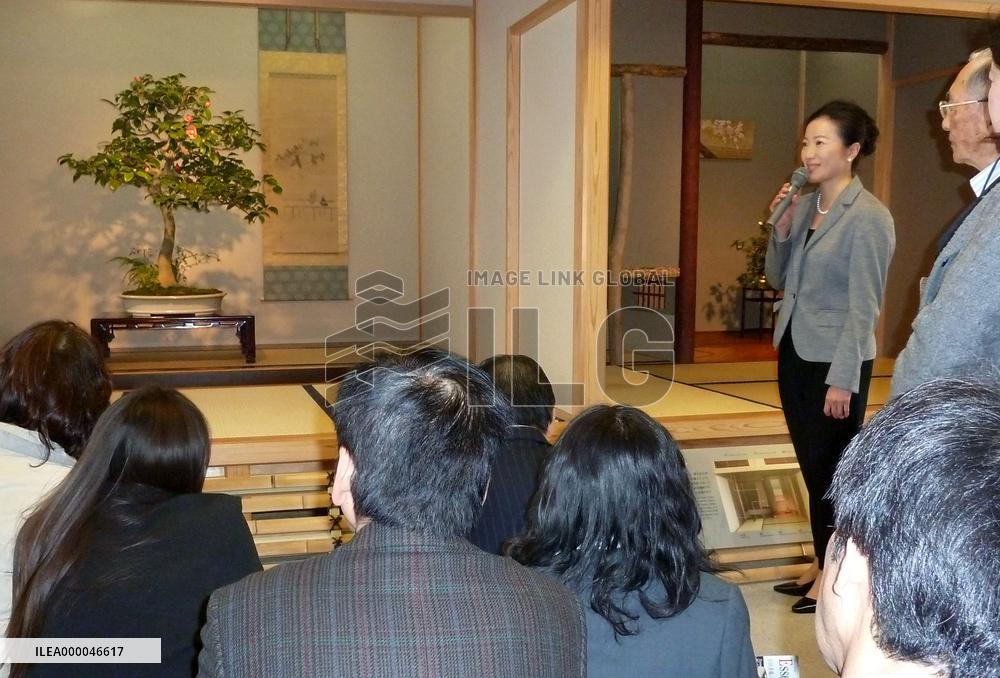 Bonsai artist explains work at exhibition near Tokyo