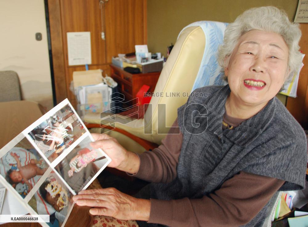 Woman shows photos of granddaughter found in quake debris in Japan