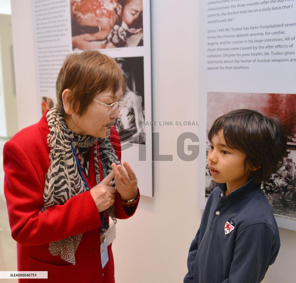 Young U.S. boy listens to A-bomb survivor at N.Y. exhibit