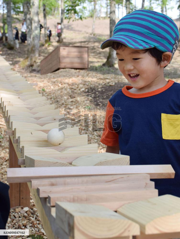Kid marvels at "forest xylophone" at Hokkaido garden show venue