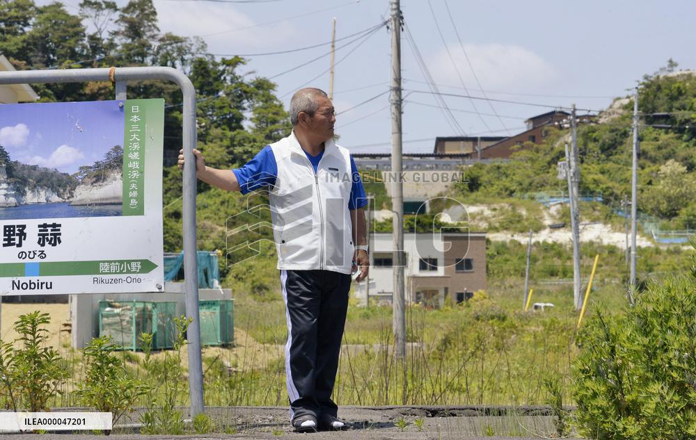 Man stands on platform of JR Senseki Line's former station