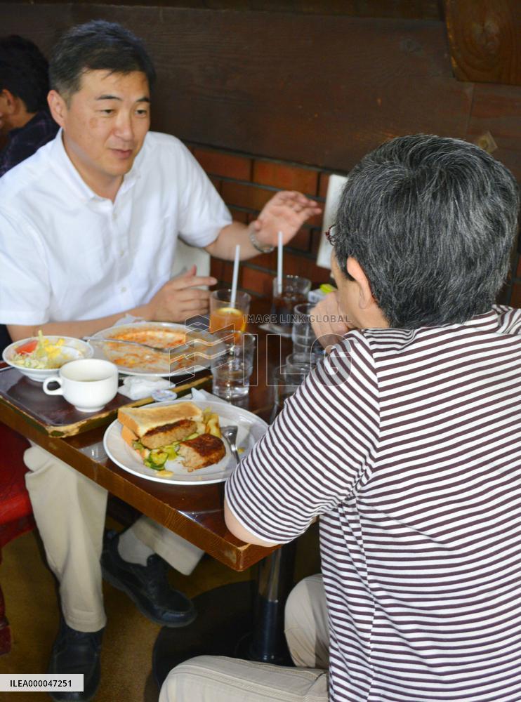 Social worker speaks with woman raising grandson in Tokyo suburb