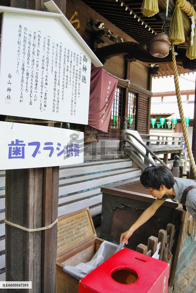 Tokyo shrine holds weekly rite to thank old brushes for dental heath