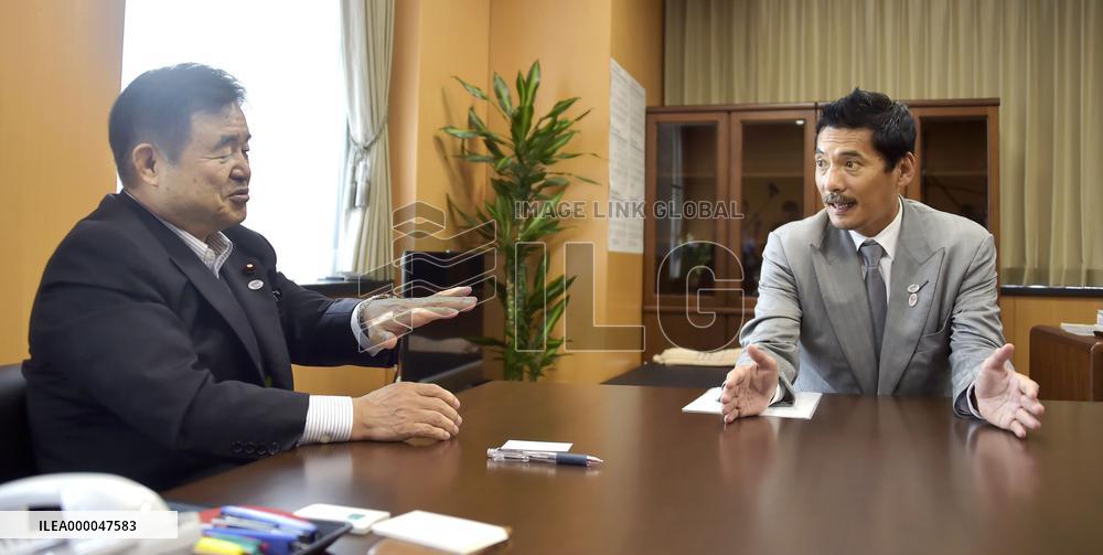 Japan's Olympics minister speaks with retired rugby star