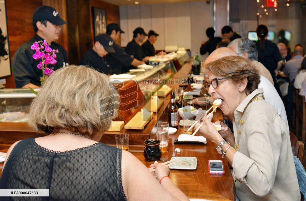 New Yorkers enjoy sushi at high-end restaurant