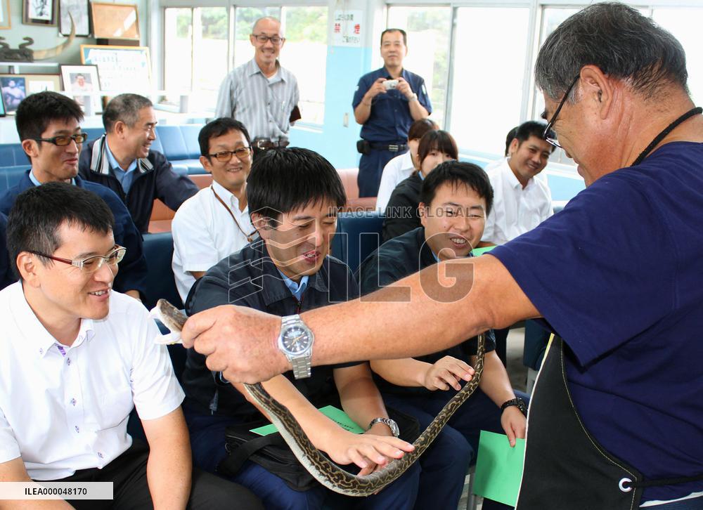New police officers learn about fanged snake in southwest Japan