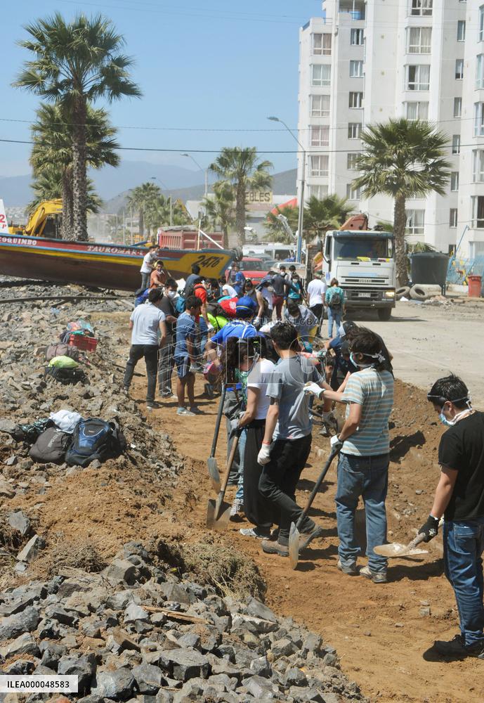 Volunteers clean up tsunami debris in Chile