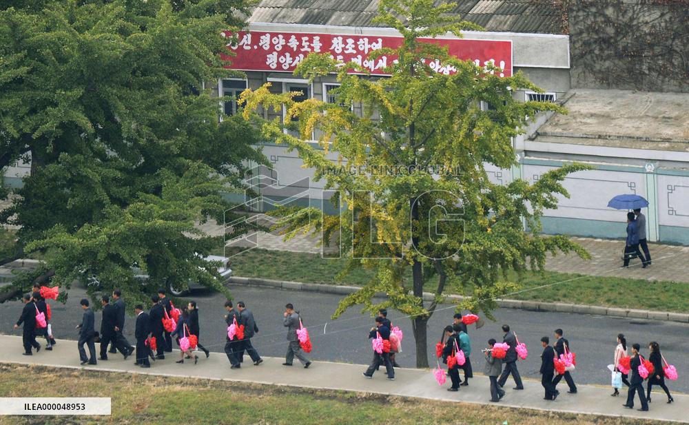 N. Korean citizens walk for military parade marking 70th party anniv.