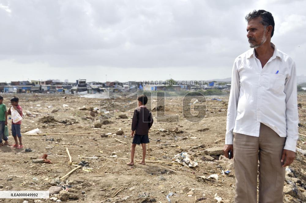 Indian NGO worker stands in suburban Mumbai slum