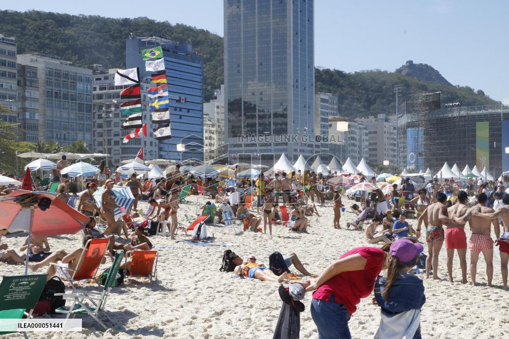 Olympic torchbearer king of the hill at Copacabana Beach