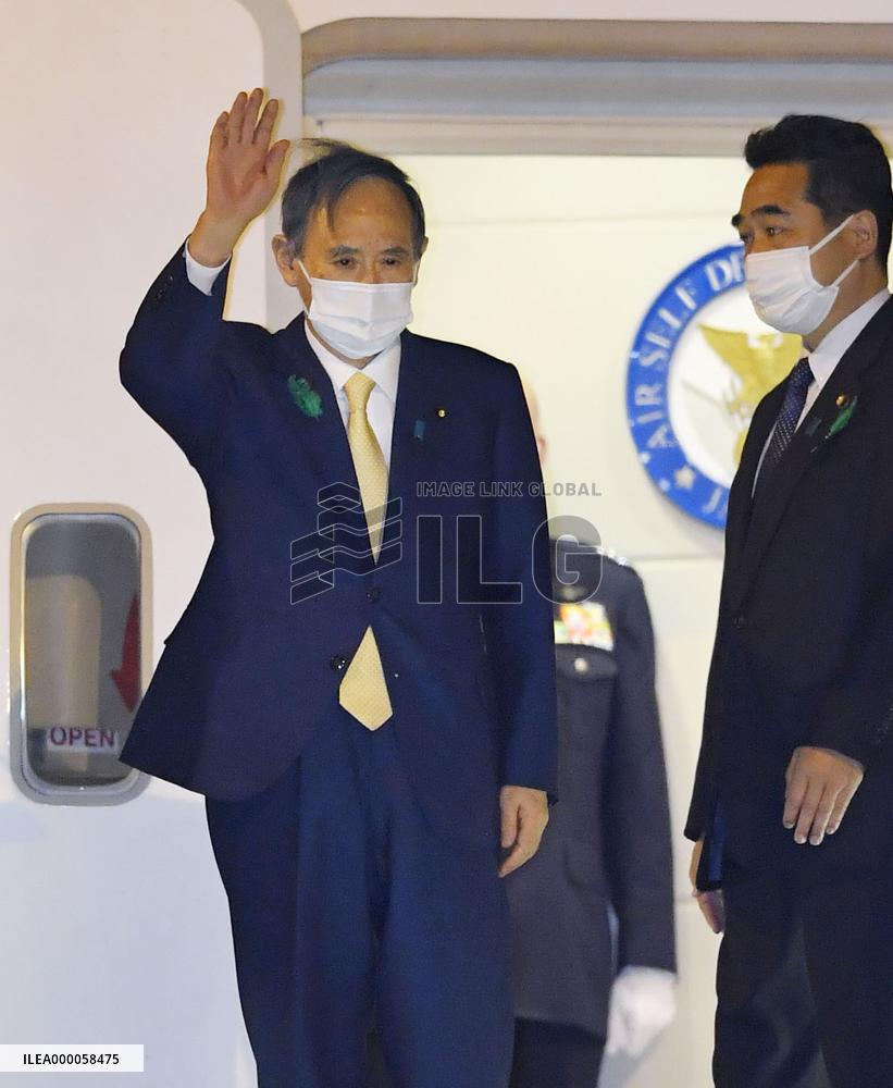Suga heads to Washington for talks with Biden