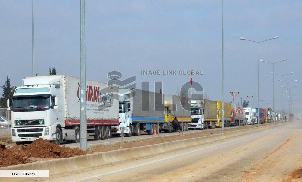 Aid supply trucks at Turkey-Syria checkpoint