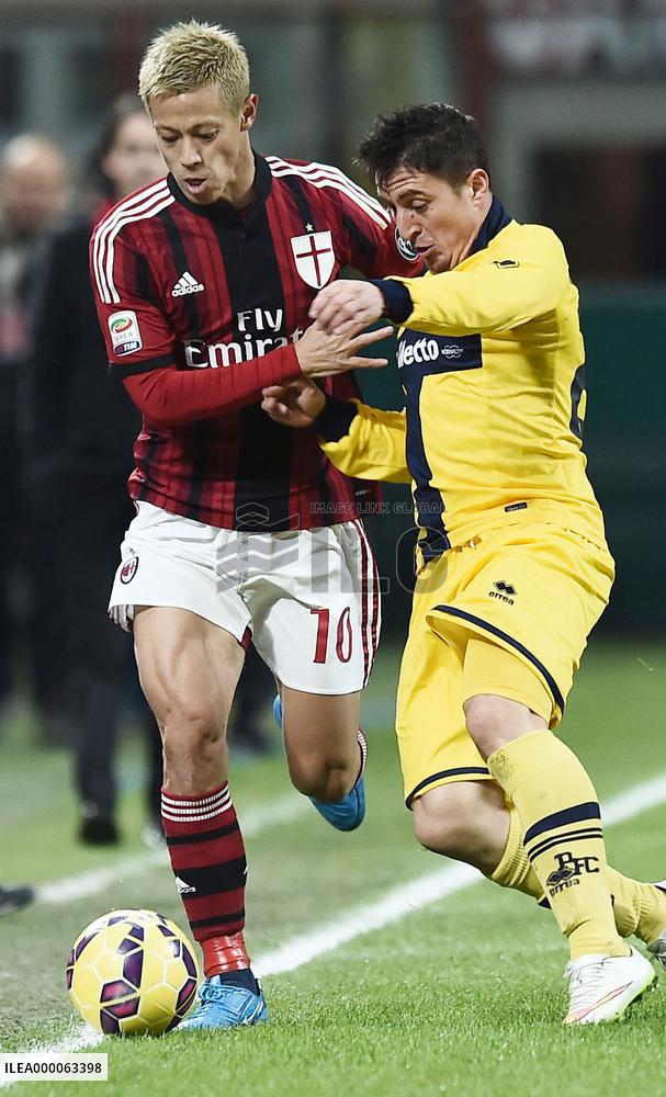 Japanese MF Honda of Milan tussles for ball with Parma player