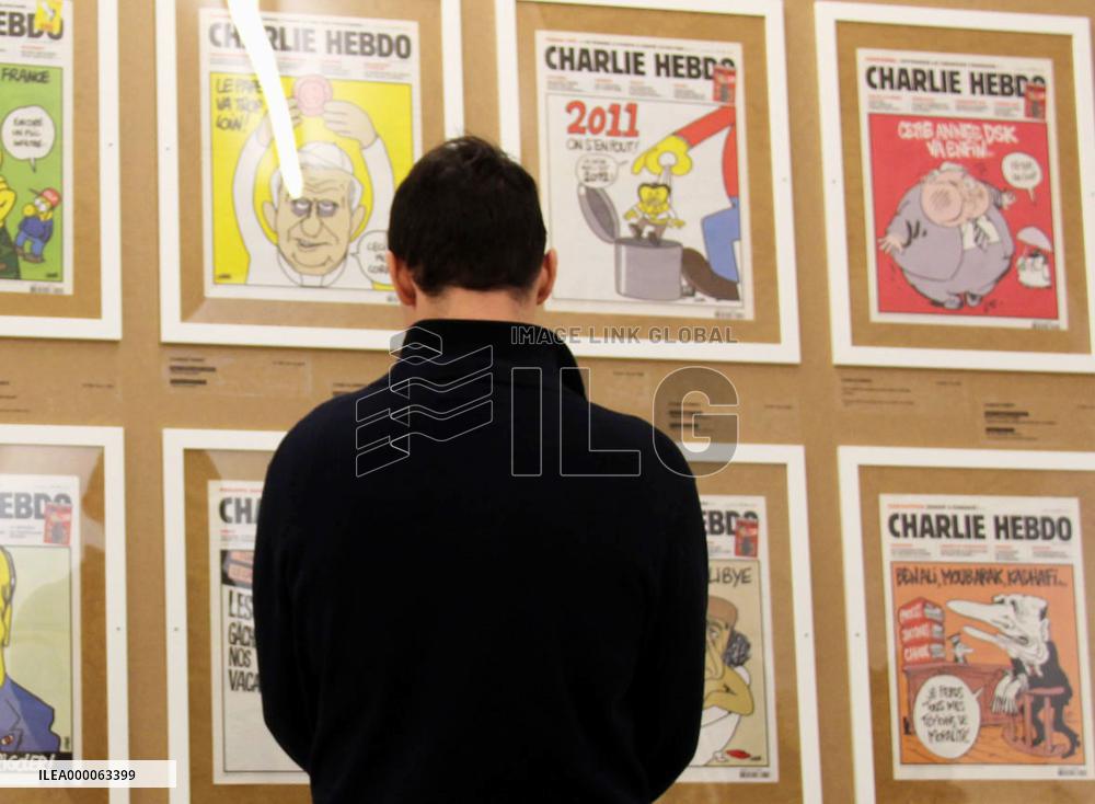 Man looks at Charlie Hebdo cartoons at exhibition in Prague