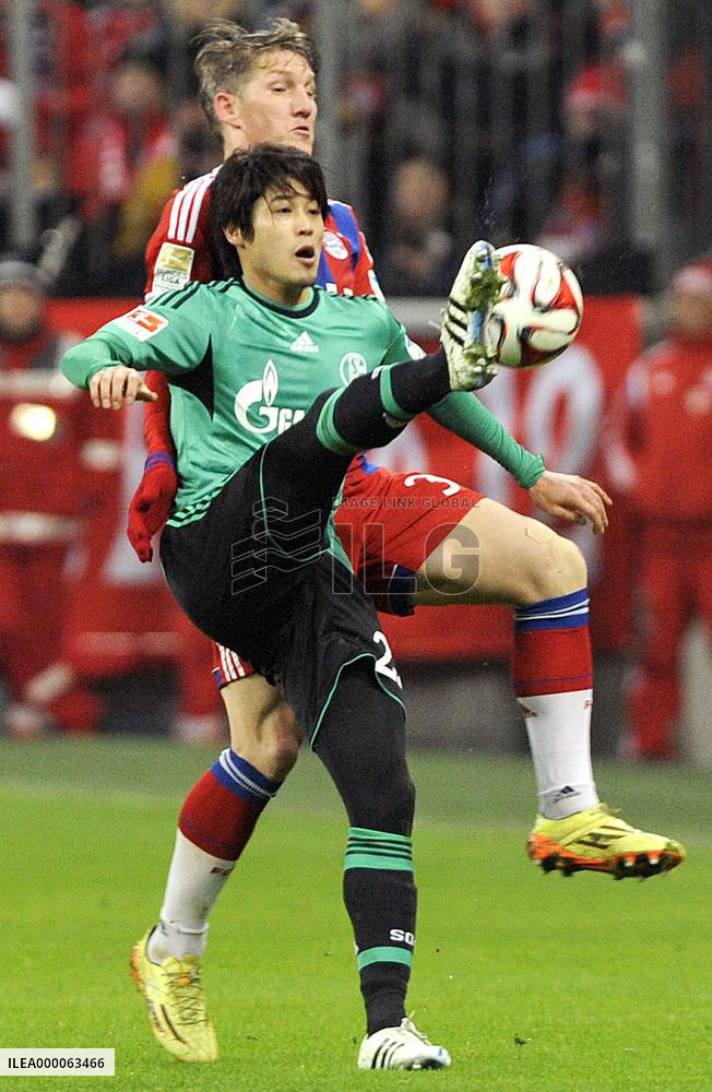 Japan defender Uchida of Schalke tussels for ball with Munich player