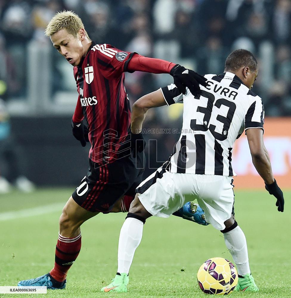 Japan MF Honda of Milan tussles for ball in game against Juventus