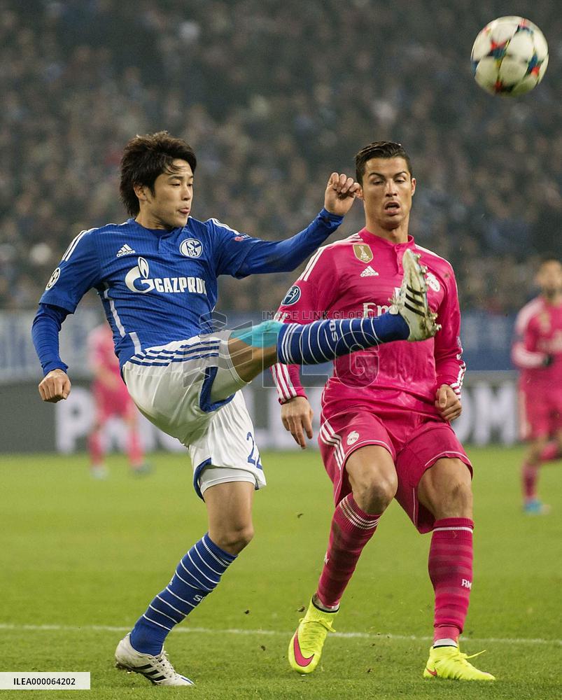 Japan defender Uchida of Schalke fights for ball with Ronaldo