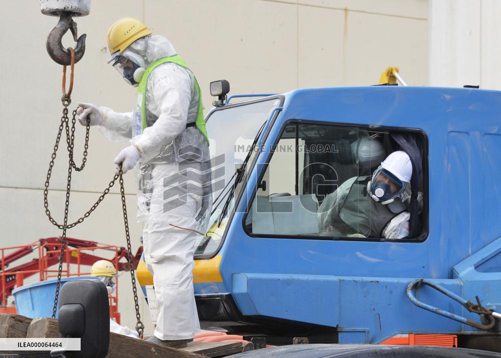 Workers in radiation-proof suits at Fukushima nuclear plant