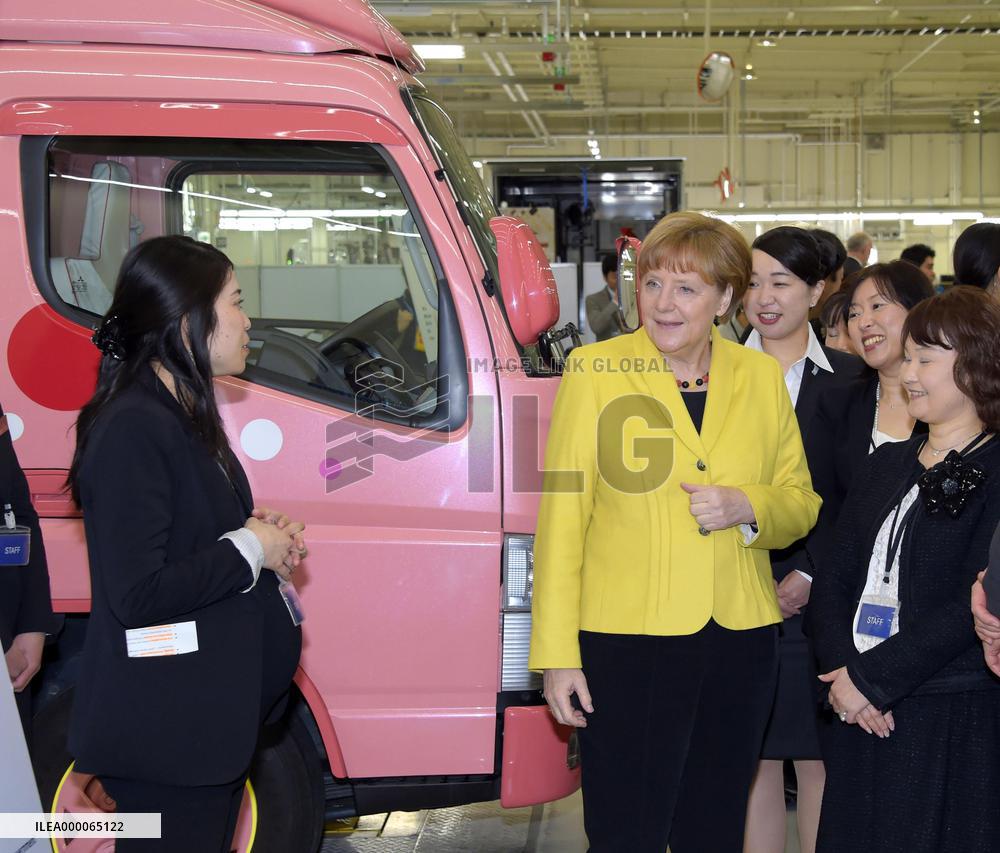 Merkel visits Daimler unit in Japan to see trucks for women