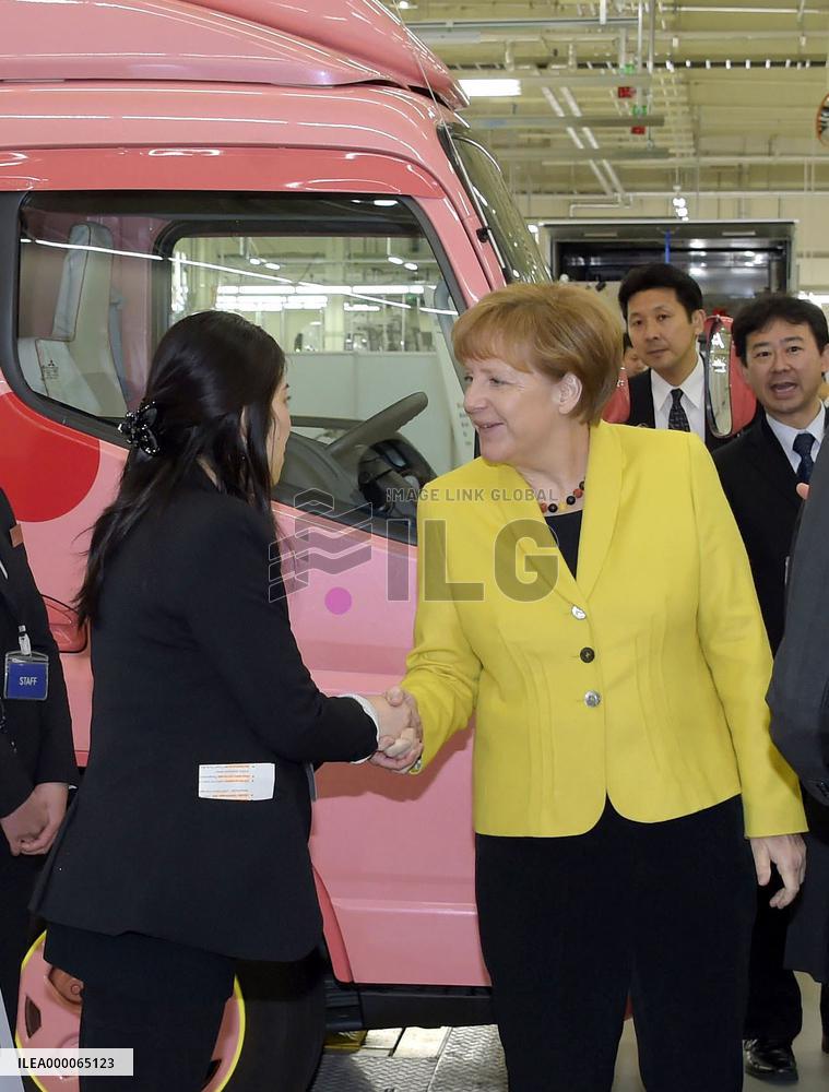 Merkel visits Daimler unit in Japan to see trucks for women