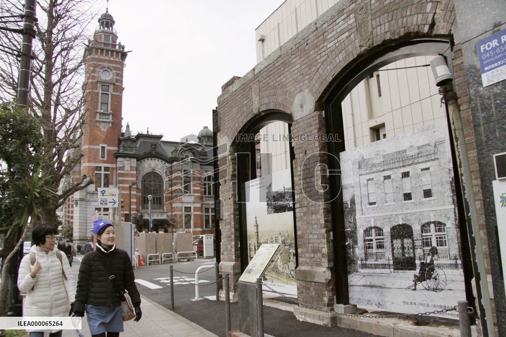 Women walk by century-old brick wall preserved in Yokohama