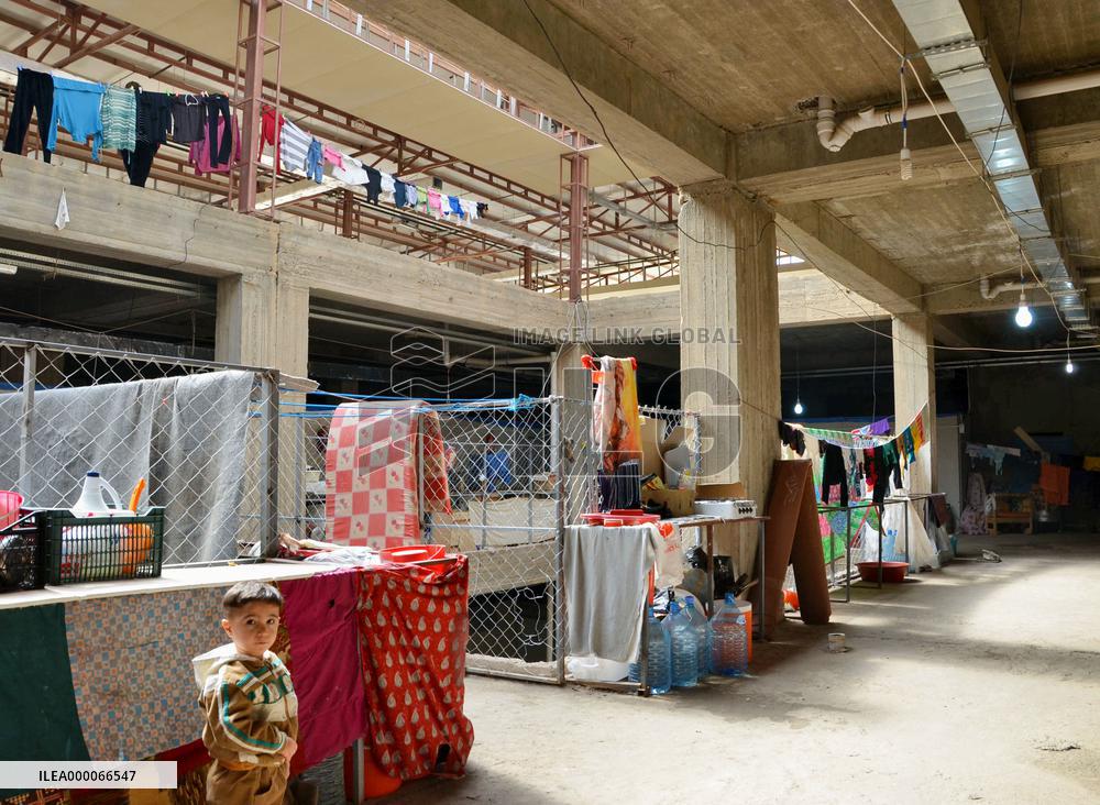Iraqi Christian refugees seek shelter in half-finished shopping mall