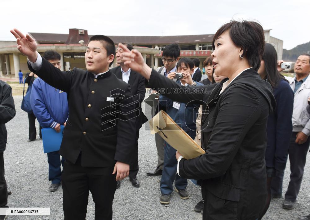 Premier's wife listens to tsunami survivor at school in north Japan