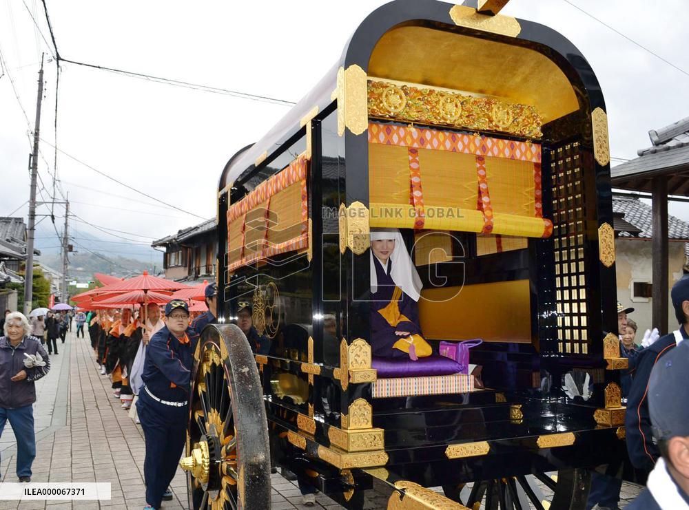 Ancient court carriage parades on approach to temple in western Japan