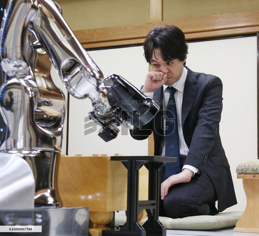 Pro shogi player beats computer program