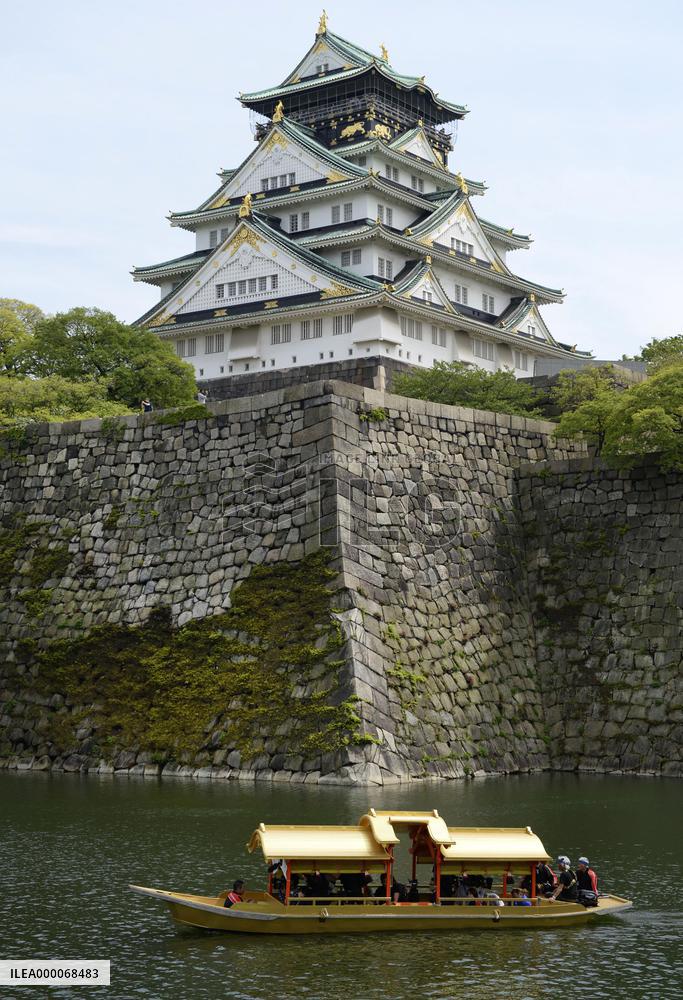 Gilded boat sails in moat around Osaka Castle at tourism blitz event