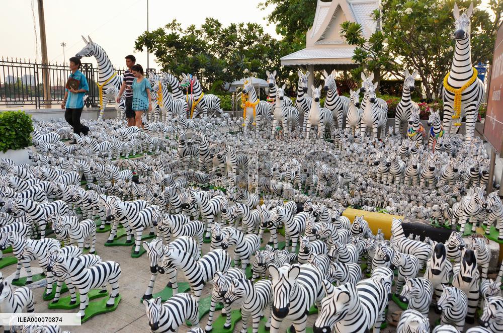 Many zebra statues displayed at animist shrine in Bangkok suburb