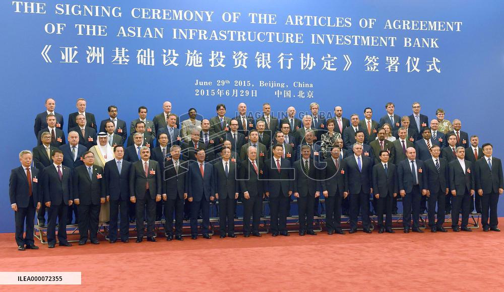 Delegates of AIIB founding members pose at inaugural ceremony