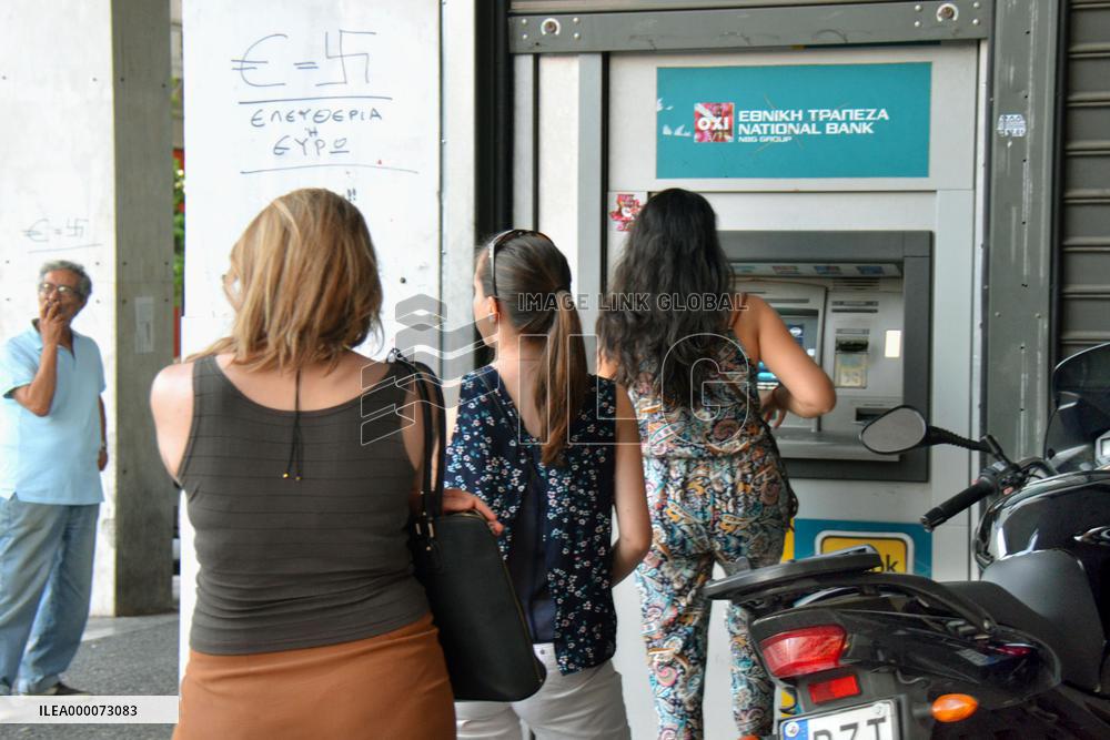 Athens citizens queue up at bank branch for cash withdrawal