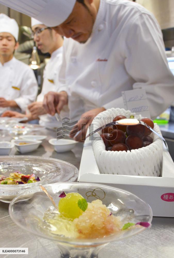 Pastry chef works beside 1 mil. yen bunch of Ruby Roman grapes
