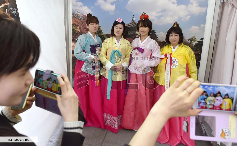 Young women clad in traditional costumes at live Korean pop event