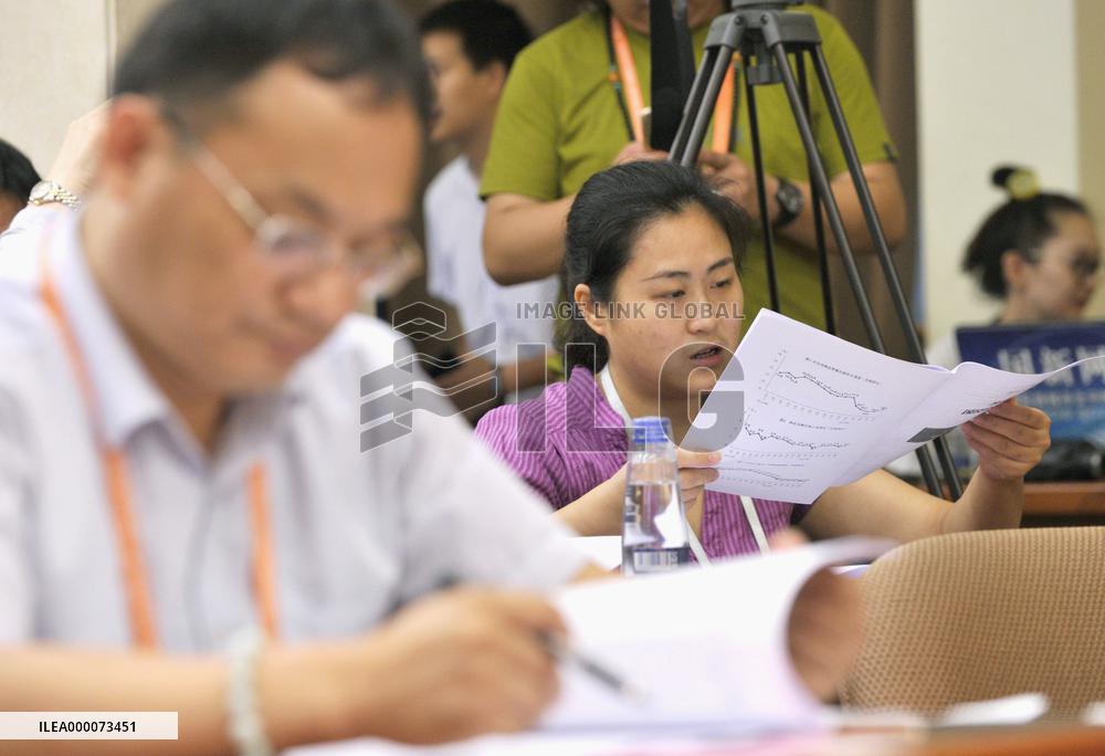 Reporters read China's GDP data